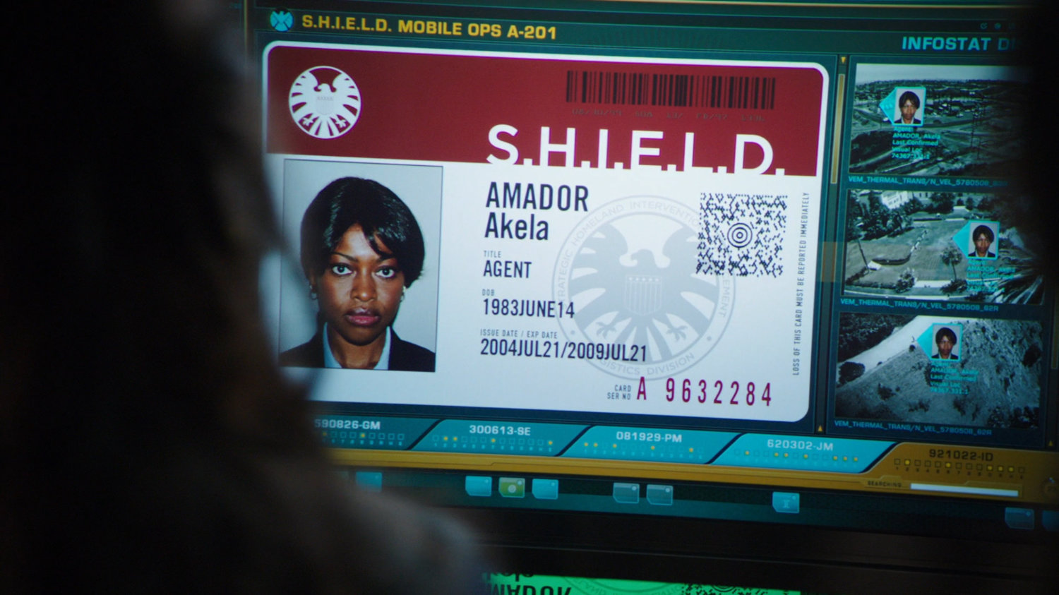 Close-up of Akela Amador's SHIELD badge.