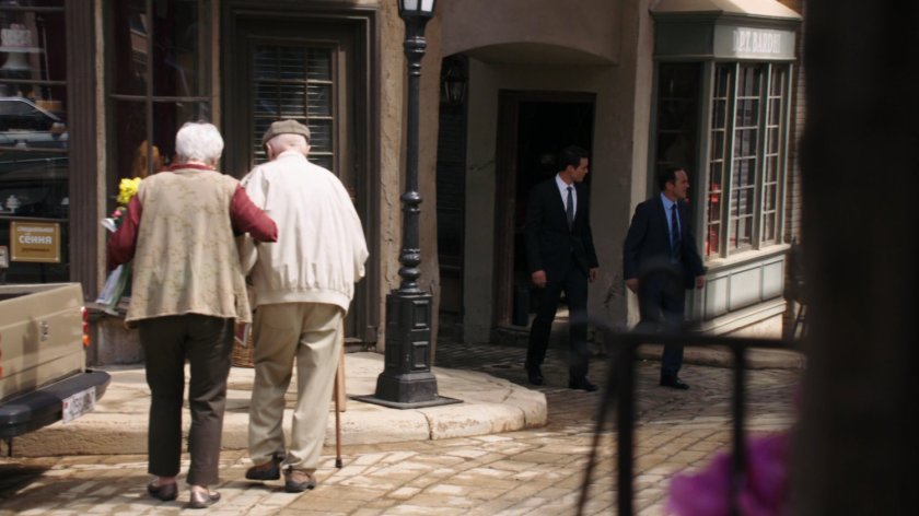 Ward and Coulson walk through a small town square in Zloda.