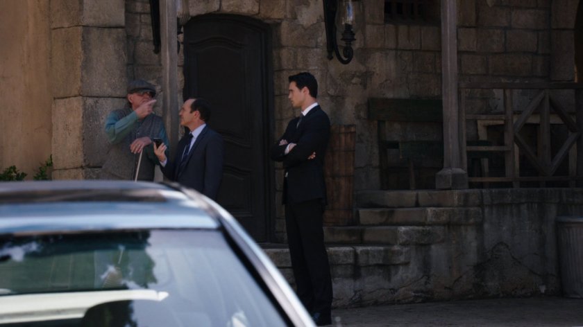 Ward and Coulson ask for directions in a small town square in Zloda.