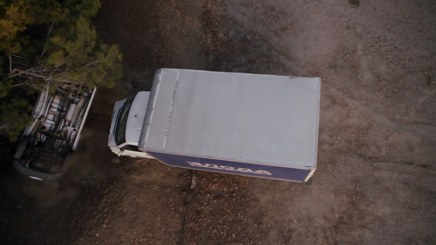 A white box truck rams a van off a road.