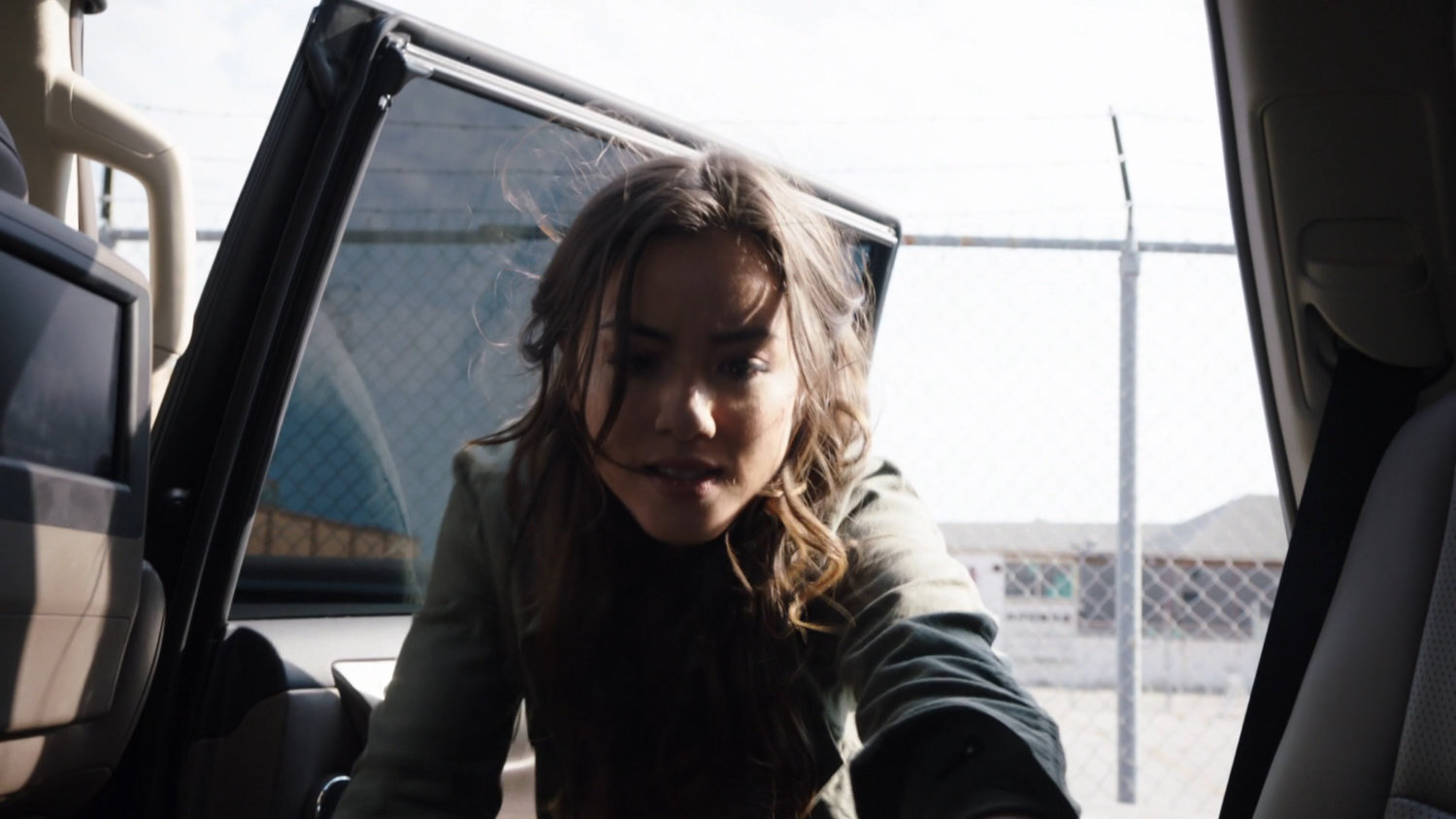 Skye getting something out of a car in the Todorov Building parking lot.