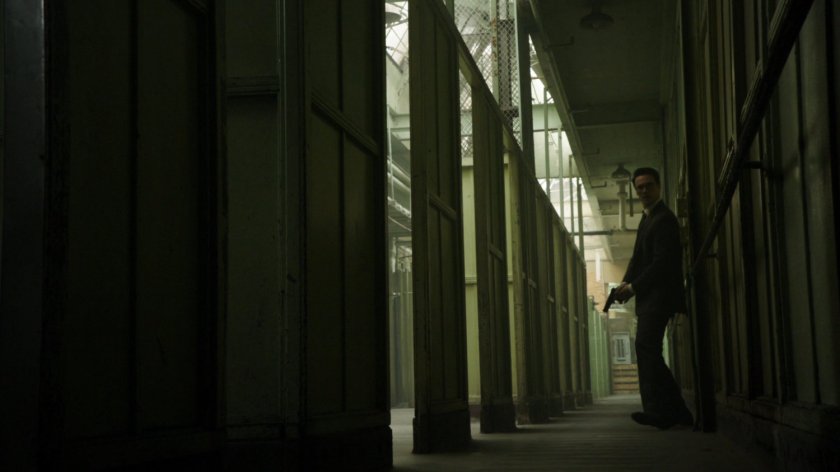 Ward in a Todorov Building hallway, gun drawn.