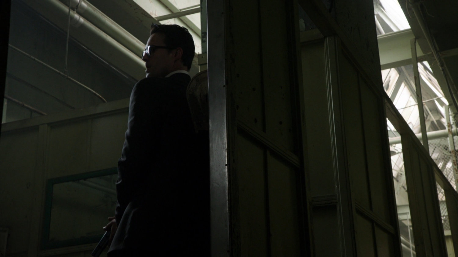 Ward hiding behind wall in Todorov Building hallway.