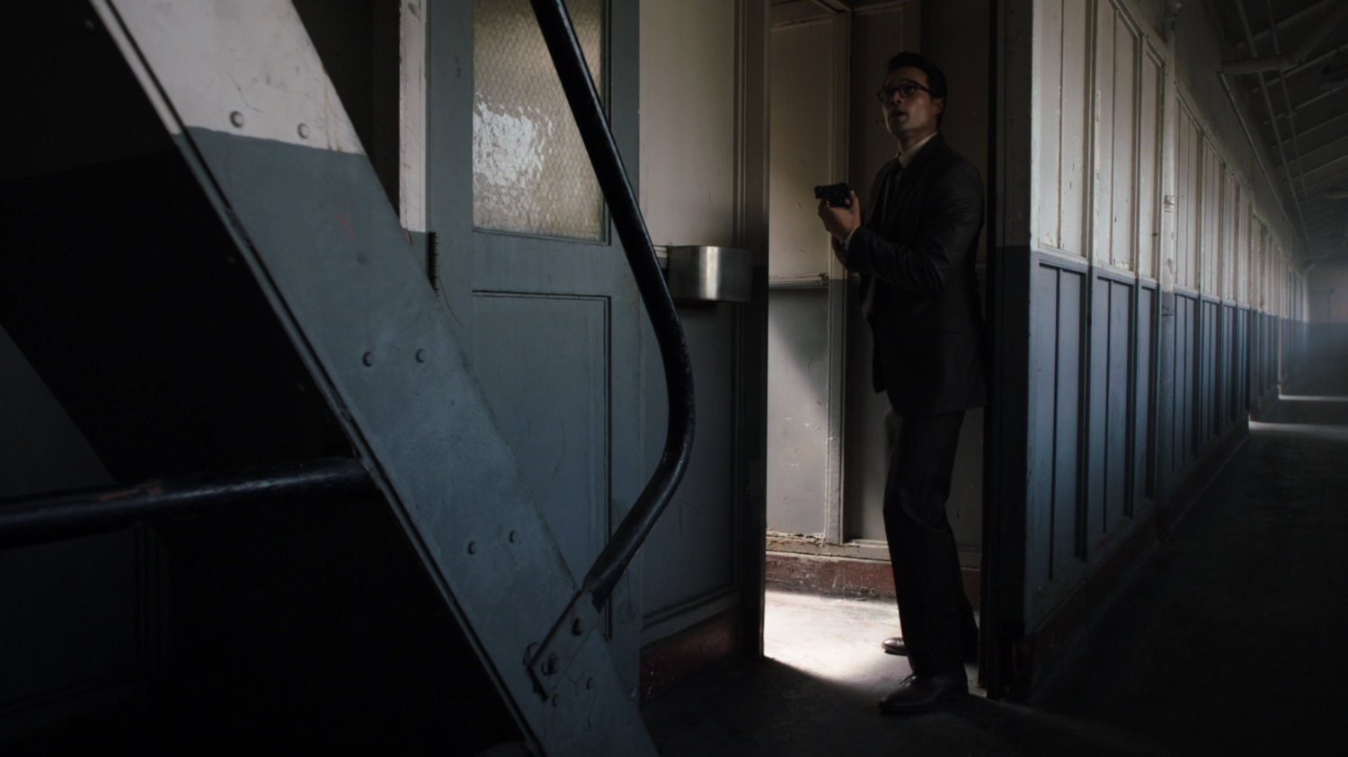 Ward hiding behind wall in Todorov Building hallway.