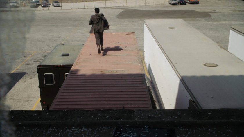 Ward running across roof of parked semi truck.