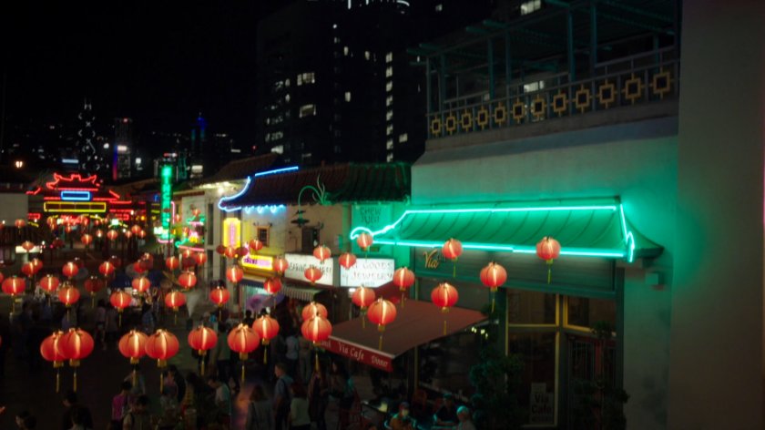 Nighttime view of Hong Kong square with red lanterns and neon lights.