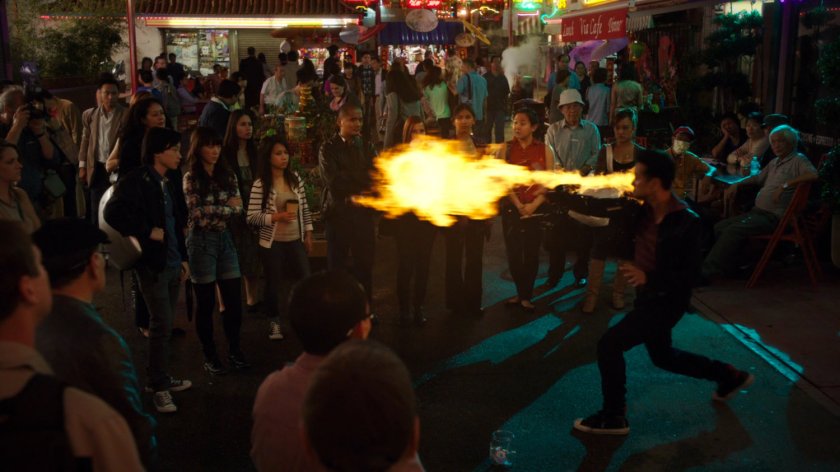 Chan Ho Yin performing street magic with fire for crowd in Hong Kong Square.