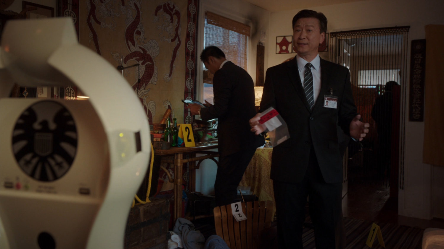 SHIELD agents inside Chan Ho Yin's apartment.
