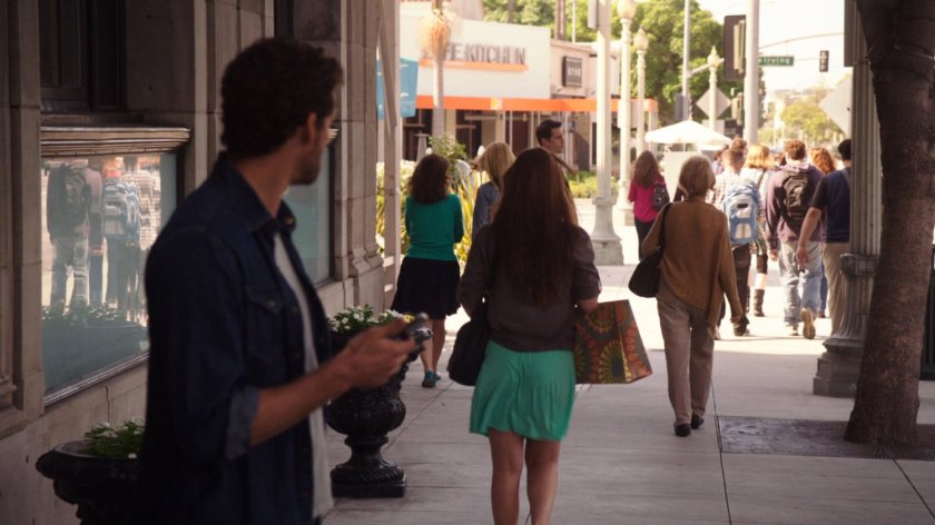 Miles Lydon watching passerby's on Austin sidewalk.