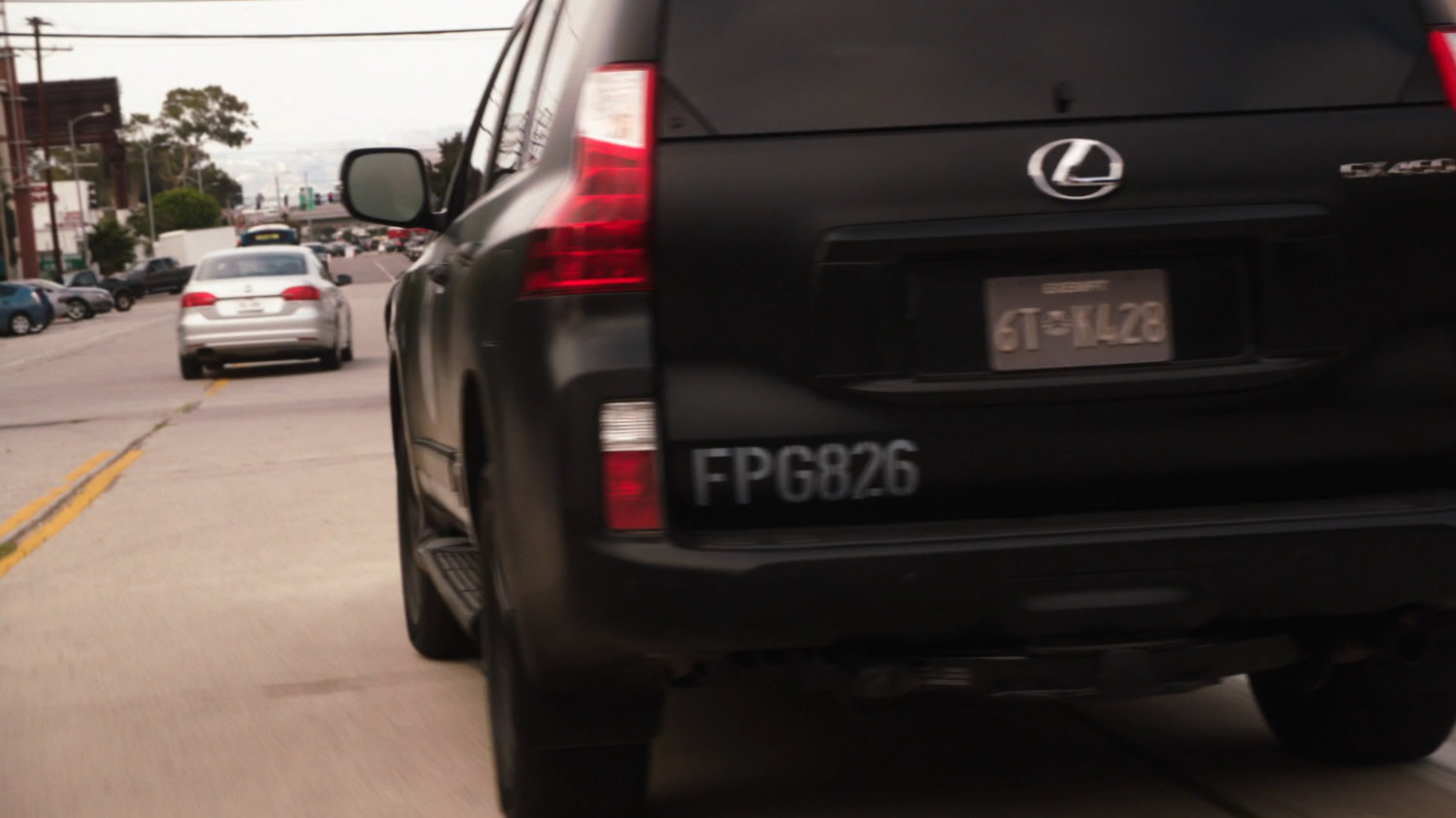 SHIELD SUV following grey car on Austin street.