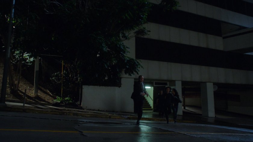 SHIELD Agents run across street outside Project Centipede Facility.