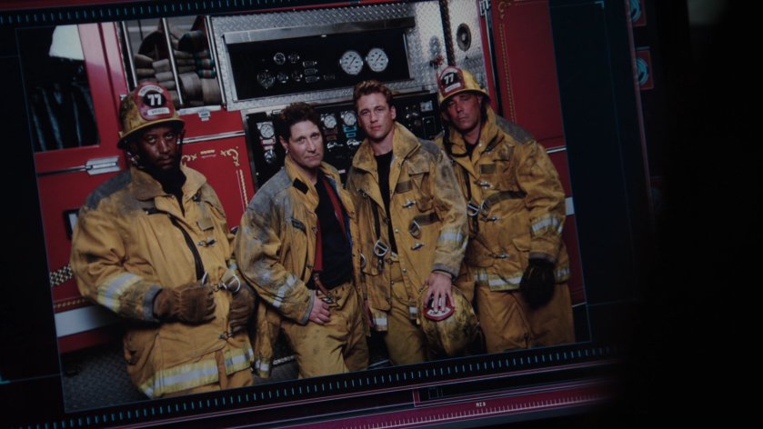 An image of four firefighters in front of fire truck.