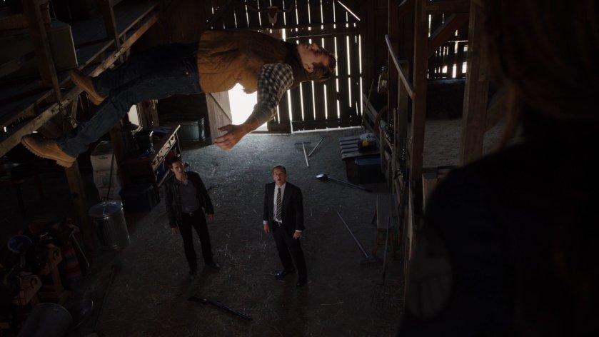 Ward and Coulson look up at a man hovering ten feet off the ground inside a barn.