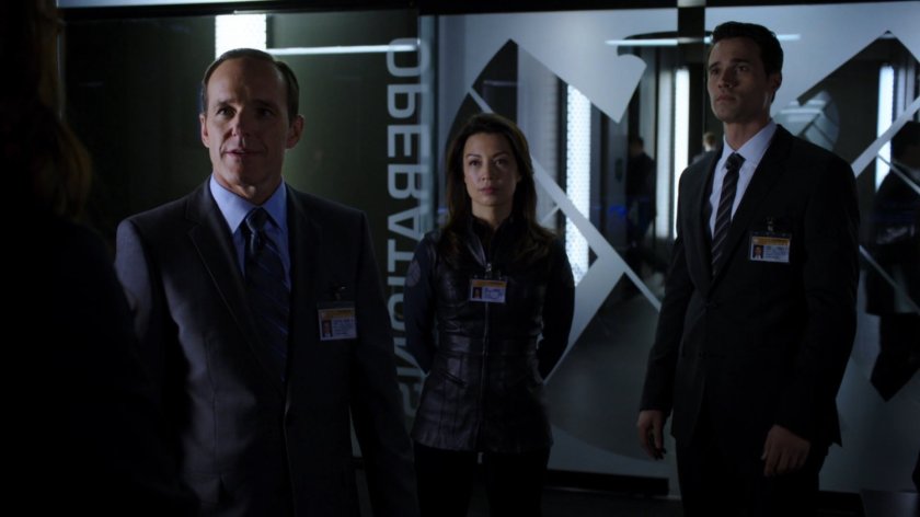 Coulson, May, and Ward just inside The Hub Operations section.