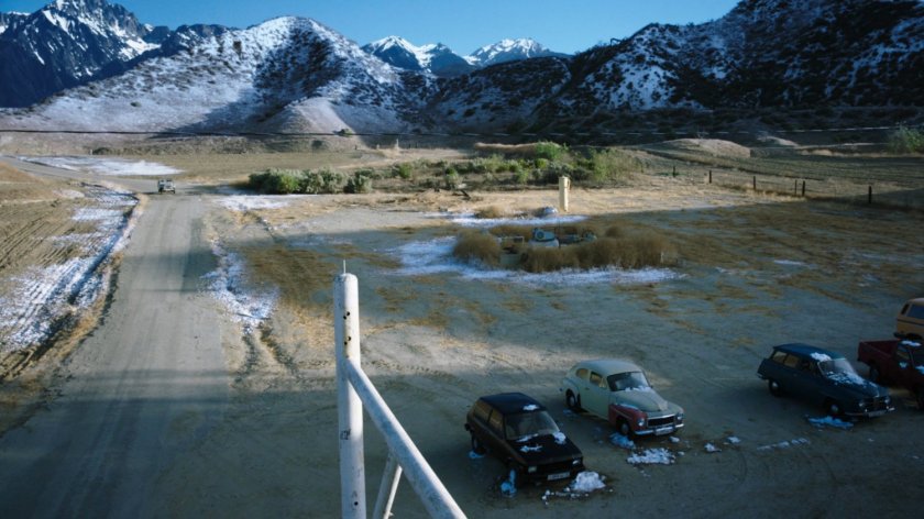 A jeep approaching a parking area outside a Caucasus Mountain bar.