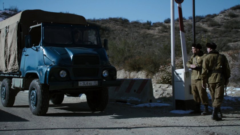 A covered truck at a Caucasus Mountain checkpoint.