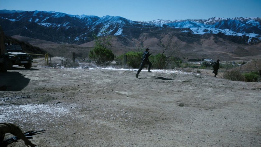 Ward and Fitz run out of a a Caucasus Mountain open area.