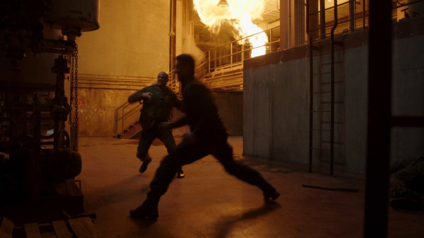 Ward fights a man as flames explode in a Georgian power plant.