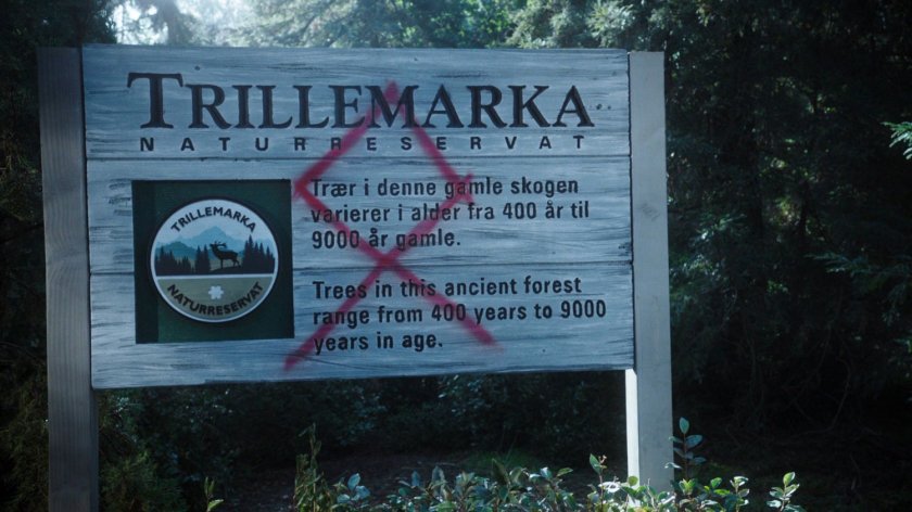 Sign for Trillemarka Nature Reserve defaced by graffiti.