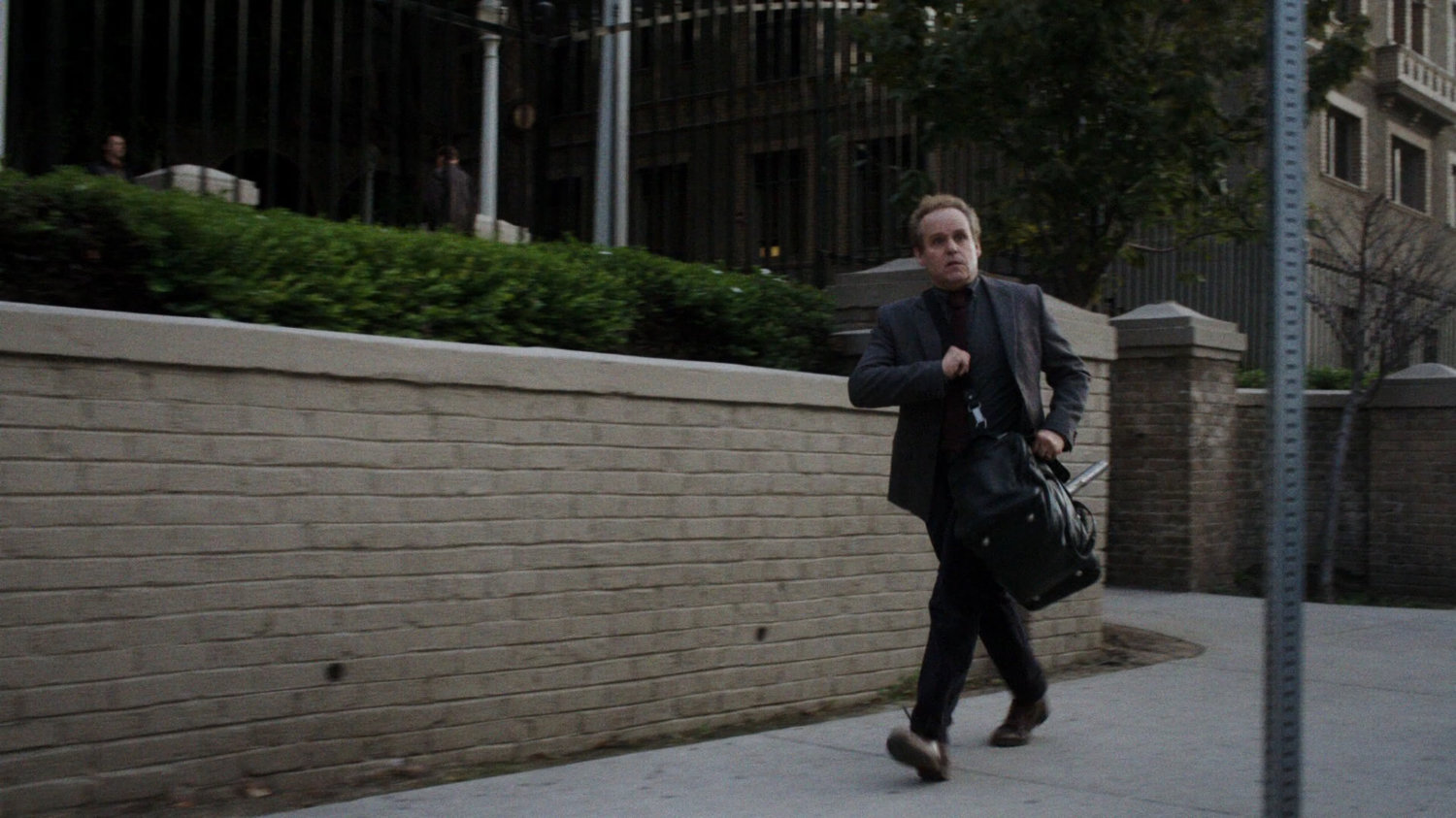 Professor Randolph on the sidewalk outside his university.