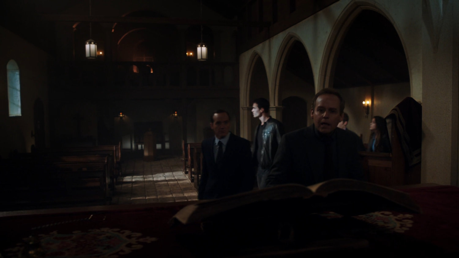 Professor Randolph and SHIELD Agents in dark interior of Irish Monastery.