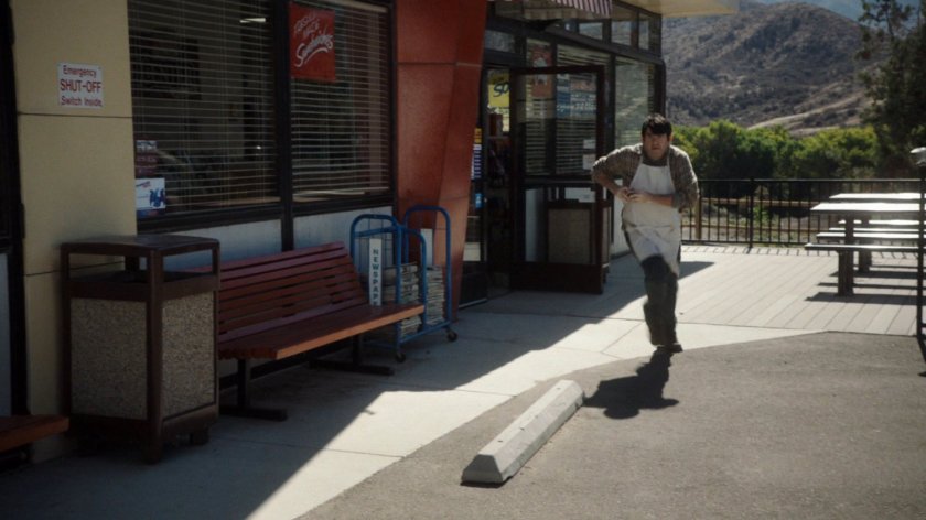 A man runs out of a convenience store.
