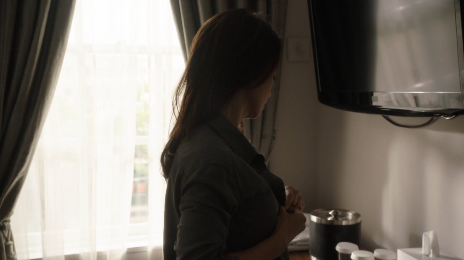 May gets dressed in a hotel room in Ireland.