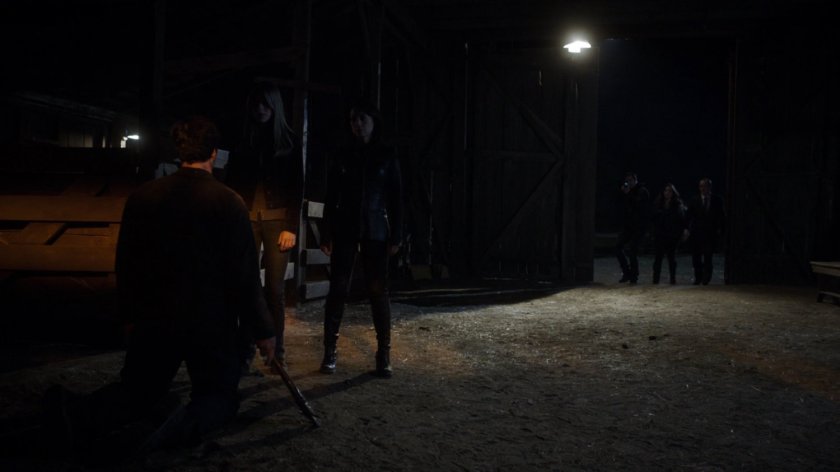 SHIELD agents in the entrance to an old barn.