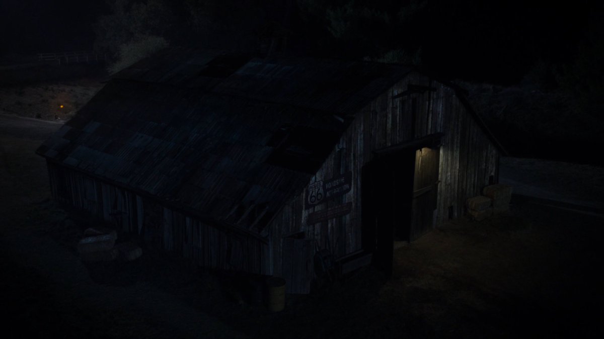 Aerial view of an old barn at night.