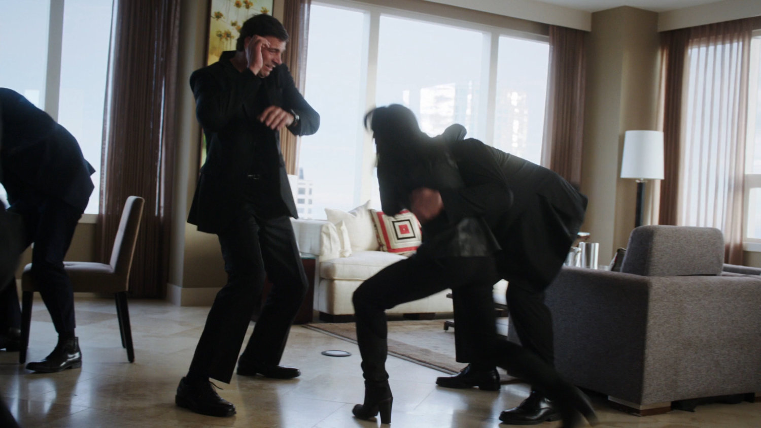 Agent May fighting security team in suite of high rise building.