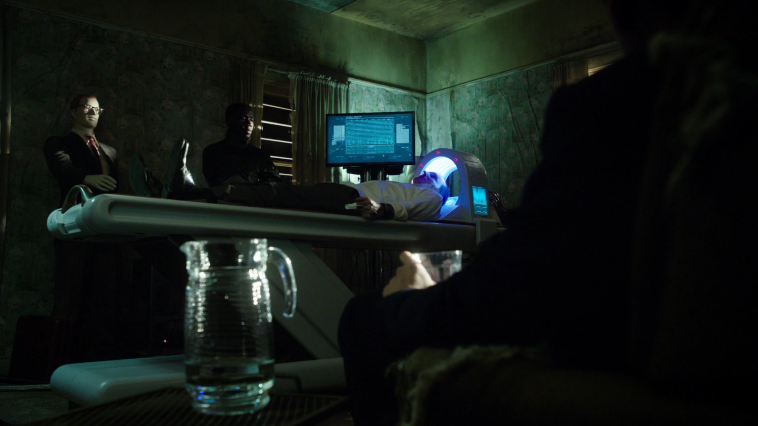 Coulson on a medical table in an abandoned building.