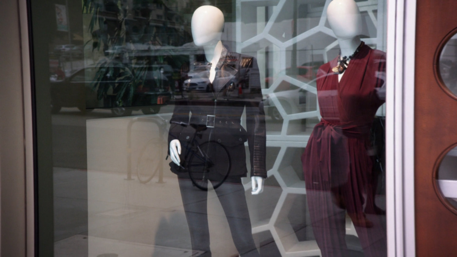 A leather coat on a mannequin in a shop window.