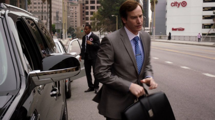 Lloyd Rathman exits his SUV on street outside his office.