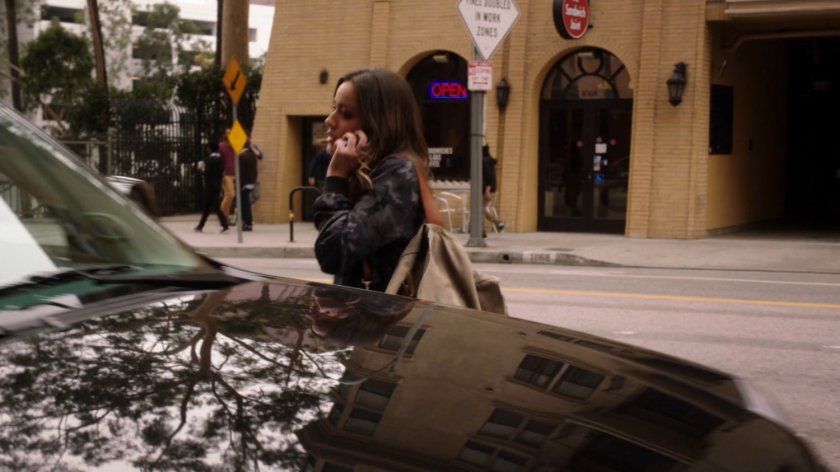 Skye on the phone getting into Lloyd Rathman's SUV.