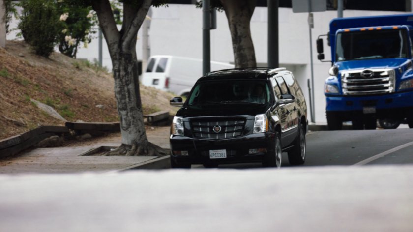 A black SUV parked on the side of the street.