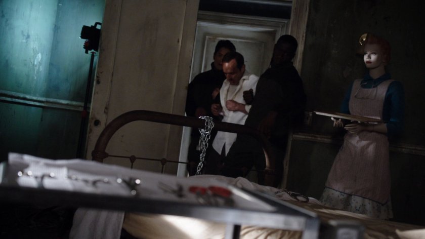 Coulson being led into an old operating theater.