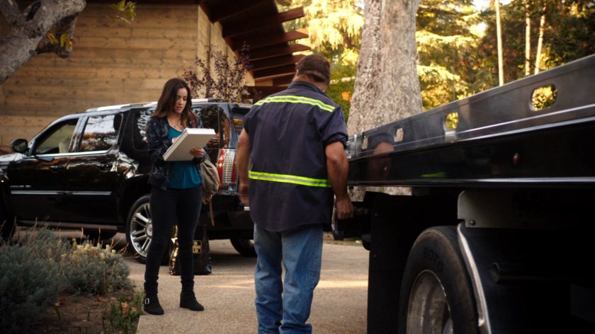 Skye in front of Lloyd Rathman's house with a tow truck driver.