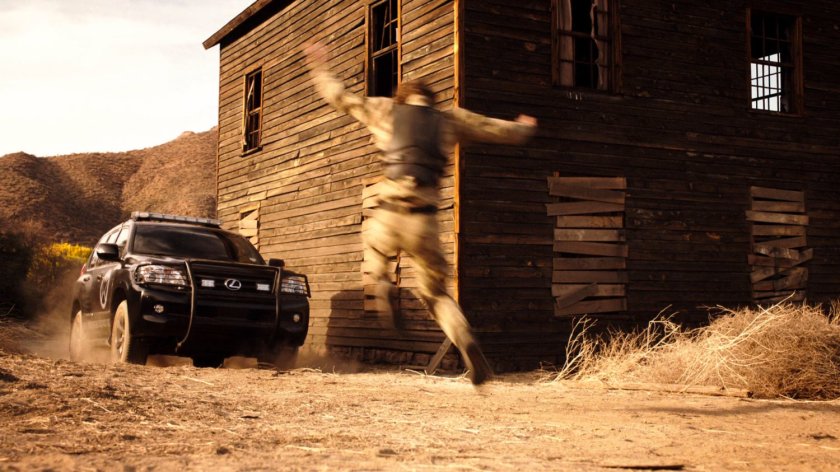 A SHIELD SUV strikes a soldier outside an atomic ghost town.