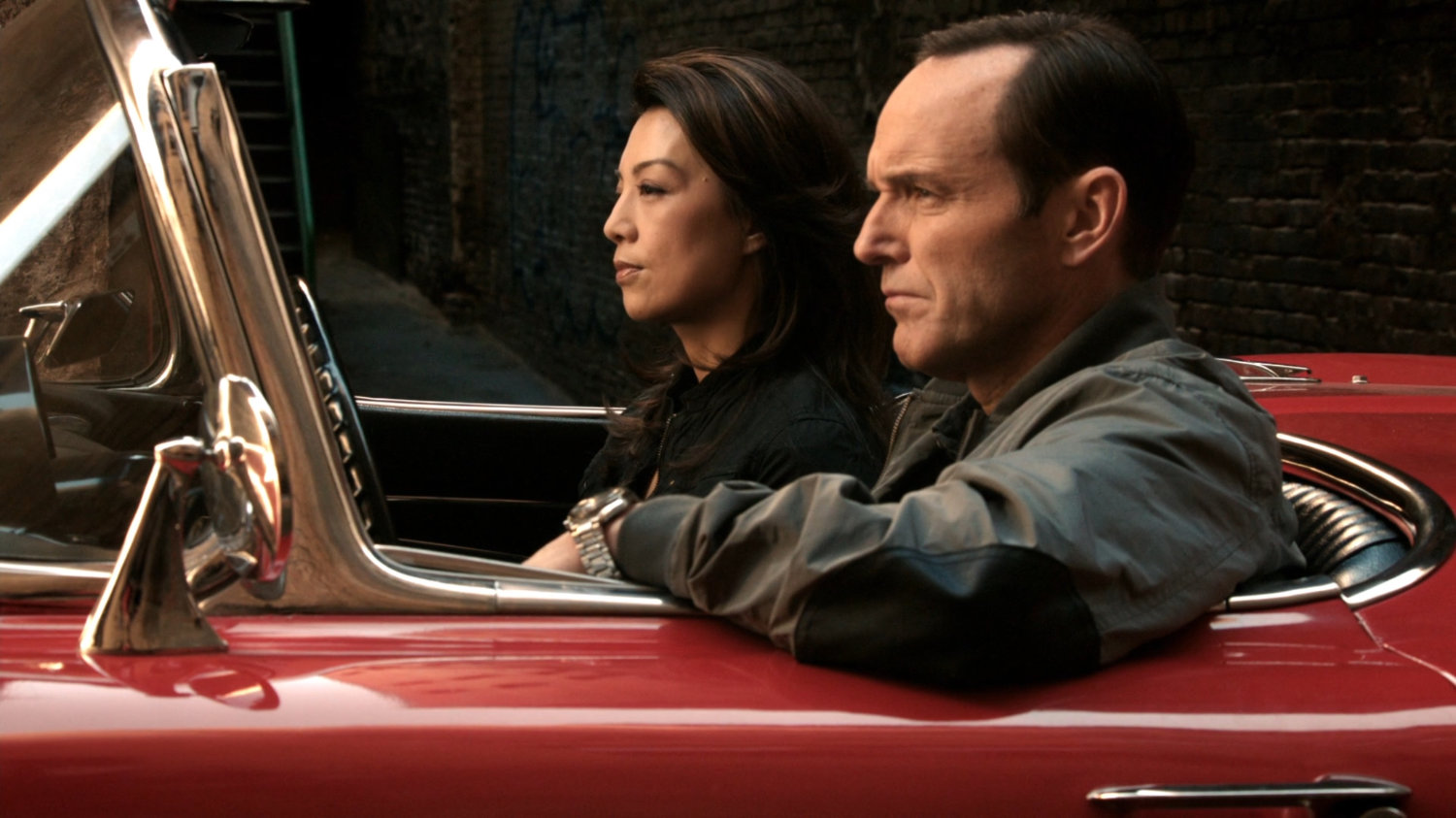 May and Coulson sit in Lola in a Mexico City alley.