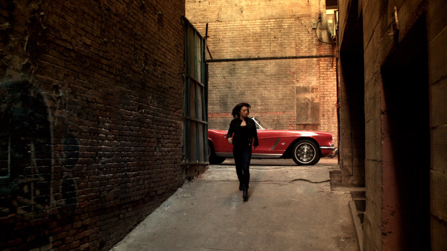 May runs down a sloped alley in Mexico City.