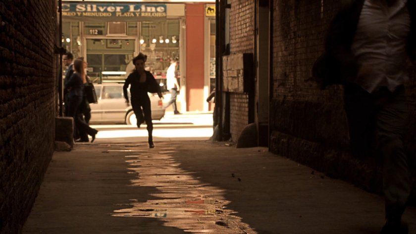 Agent May runs through a narrow Mexico City alley.
