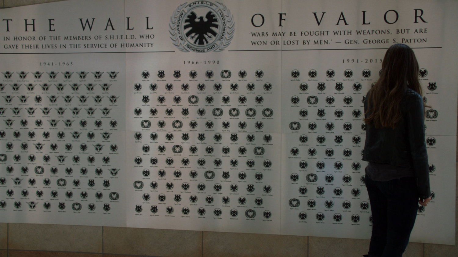 Skye looks at the SHIELD Wall of Valor.