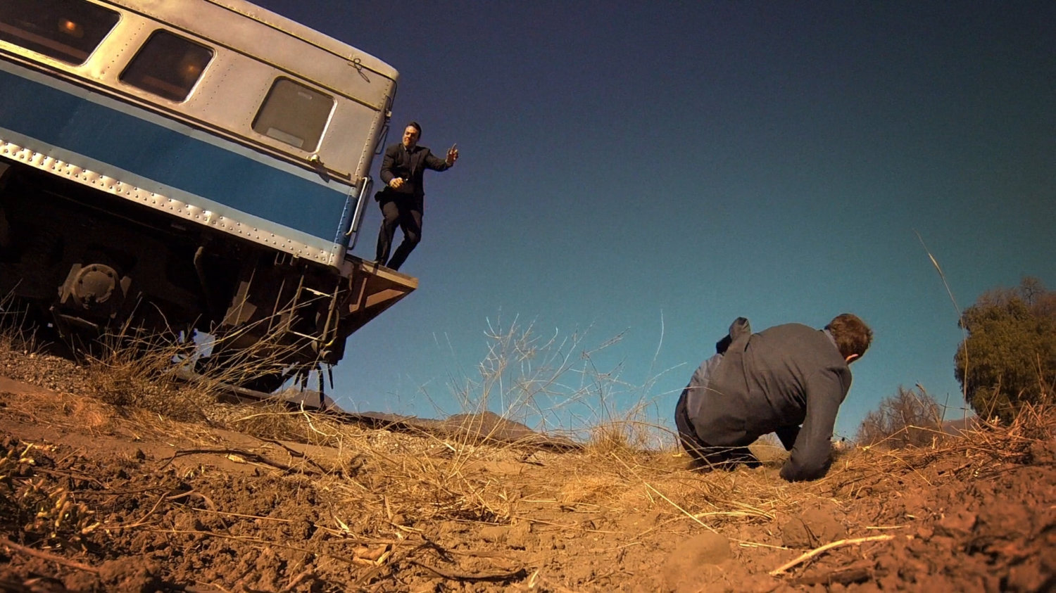 Ward and Coulson jumping off back of train.