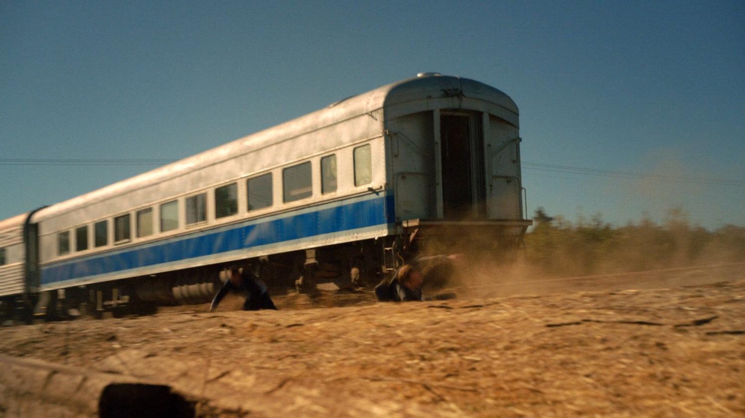 Ward and Coulson jumping off back of train.
