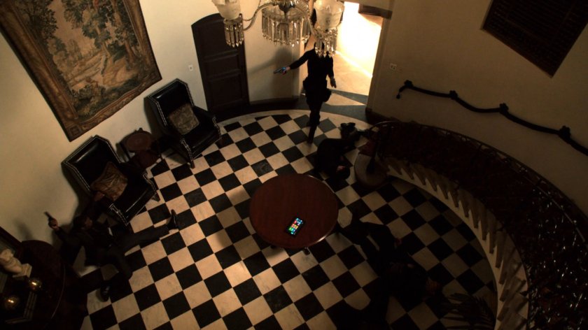 High angle of Ward in Italian villa entryway with checkerboard floor.