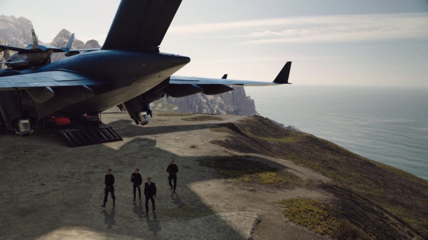 SHIELD Agents exit The Bus on a bluff near the ocean, heading towards the Guest House.