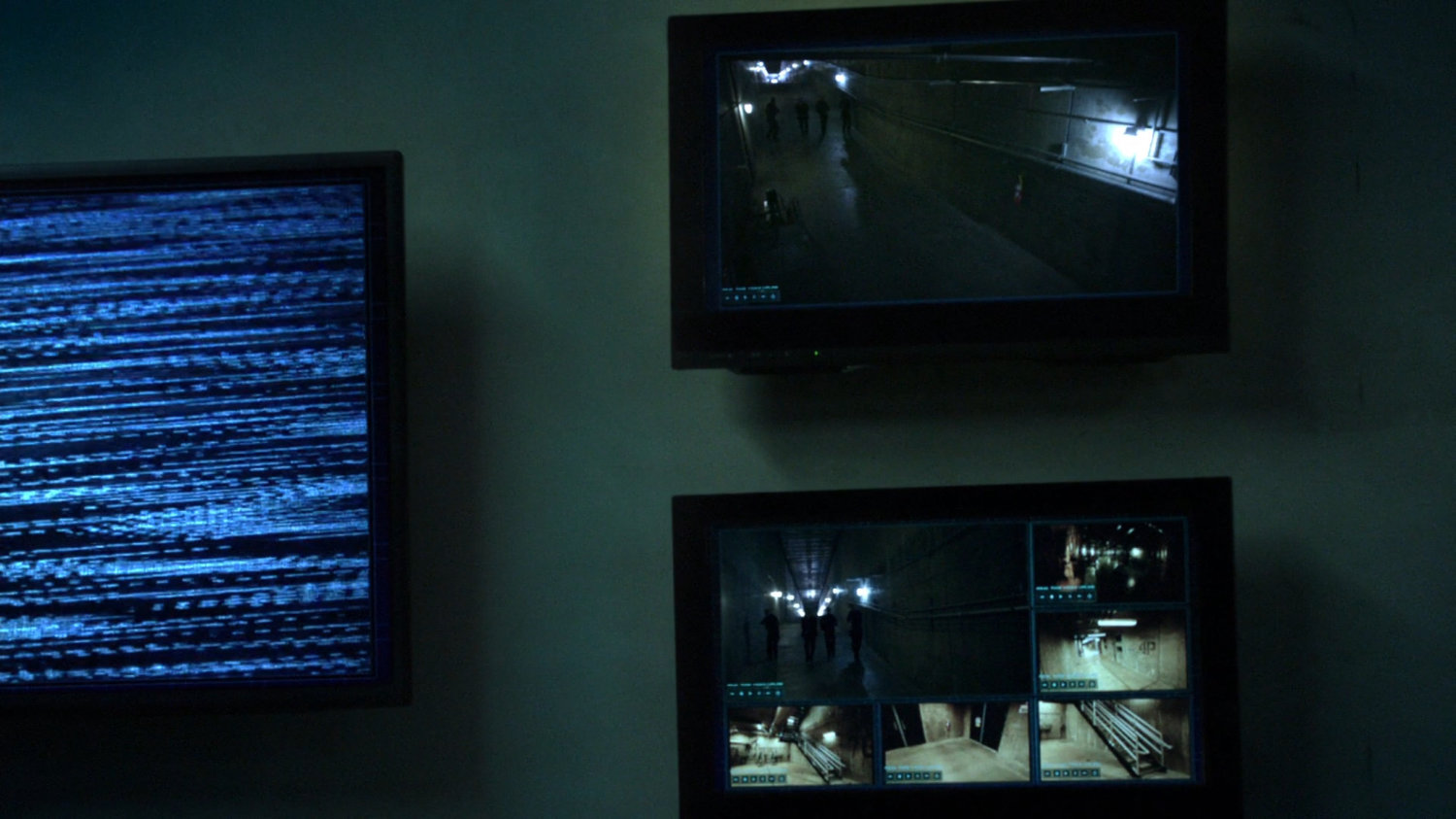 Video monitors on wall show interior views of Guest House.