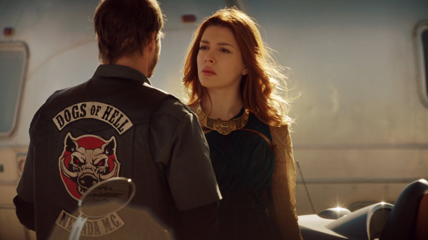 Lorelei talks to a Dogs of Hell biker.