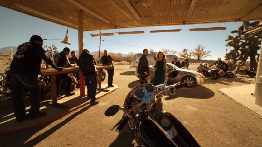 Lorelei and a group of bikers in front of Rosie's Desert Oasis in Death Valley.