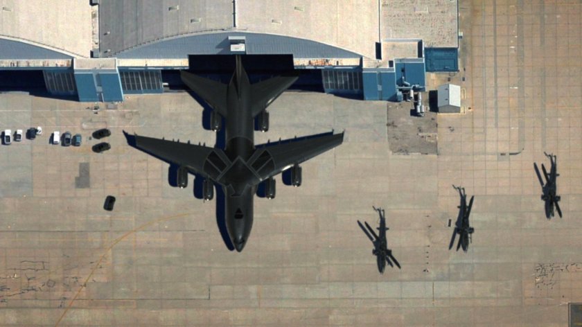 Aerial view of The Bus coming out of a hangar.